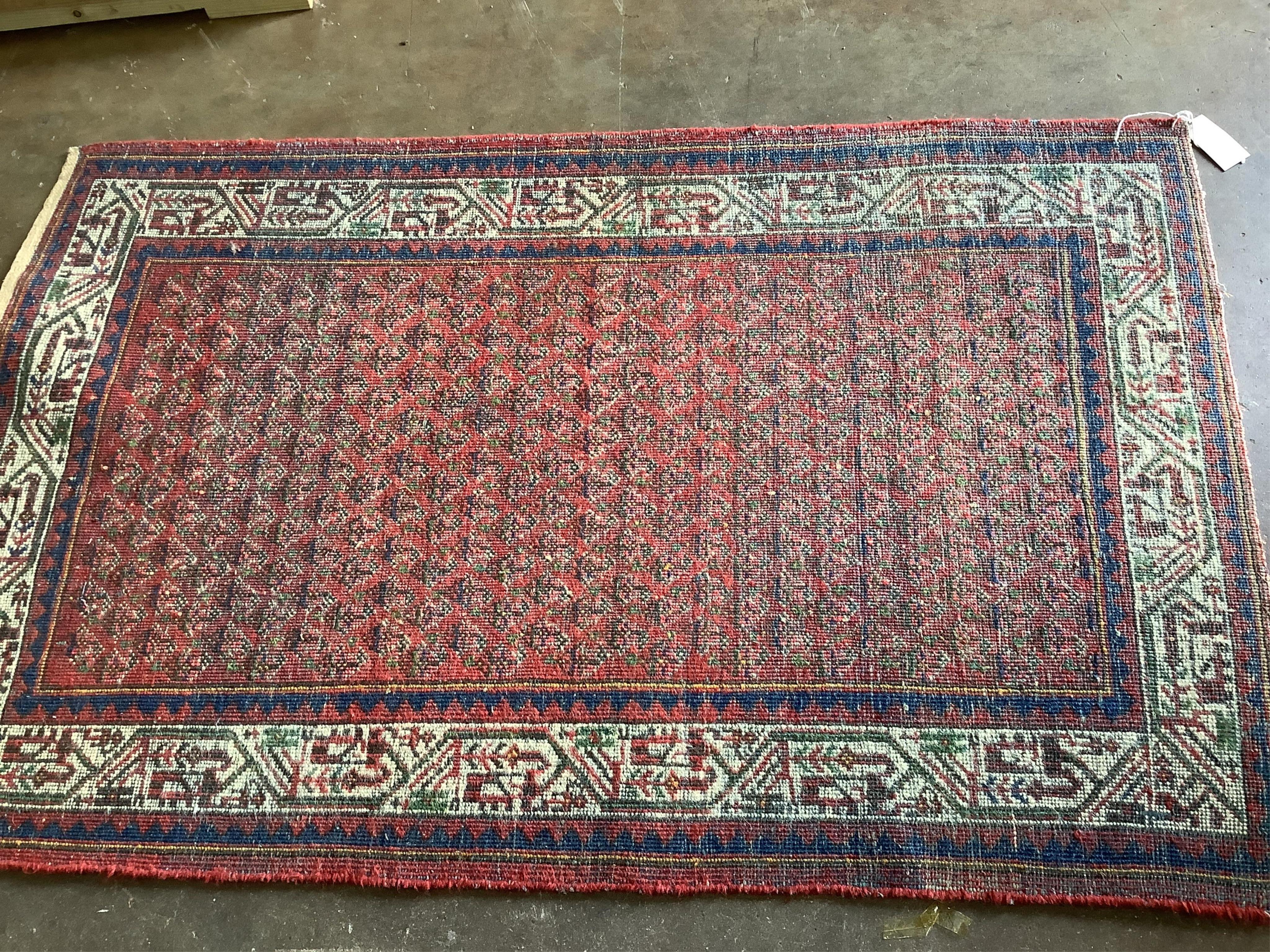 A pair of North West Persian brick red ground rugs, each 124 x 79cm. Condition - fair